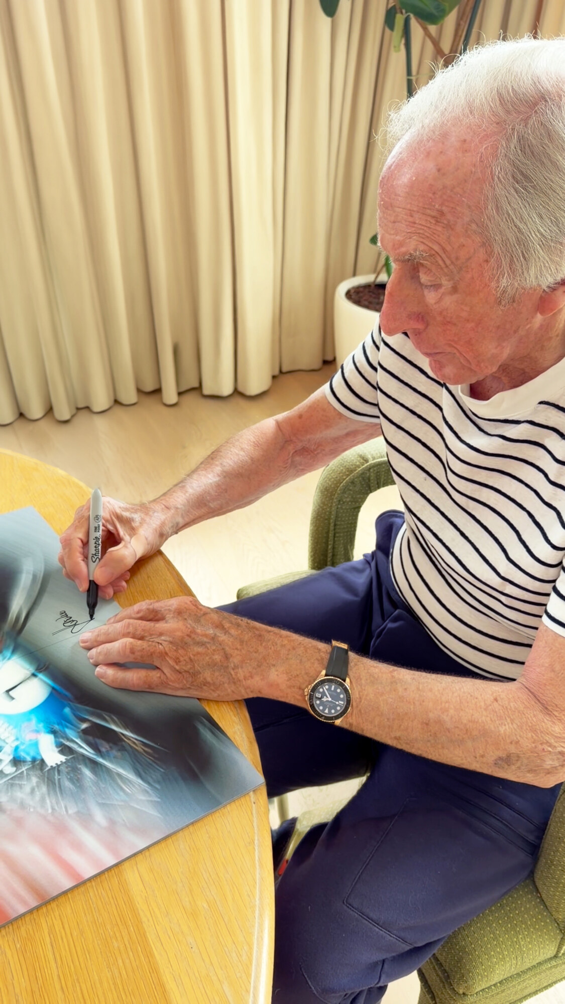 Sir Jackie Stewart signing the motion-blur spread.