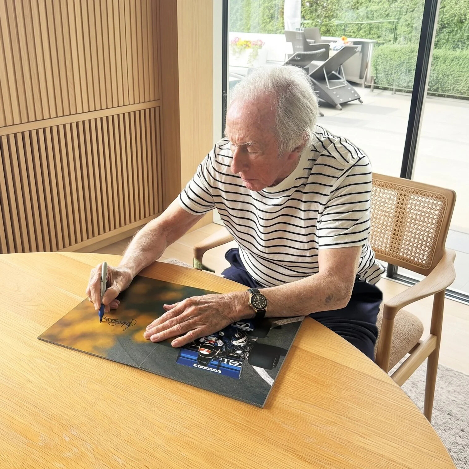 Sir Jackie Stewart signing the number 4 spread. Web resolution only.