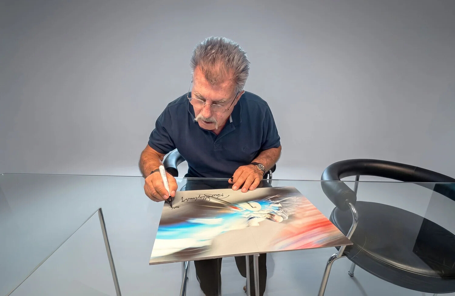 Rainer W. Schlegelmilch signing the motion-blur spread. Web resolution only.