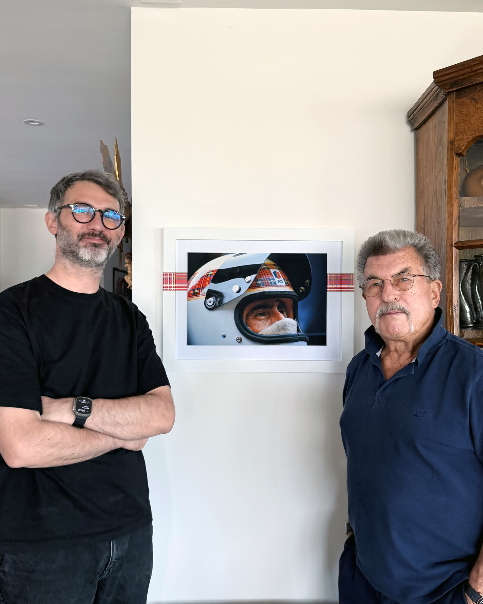 Rainer W. Schlegelmilch, right, with Devis Gastaldon, founder, left, beside a Framebook showing the helmet spread. Vertical.